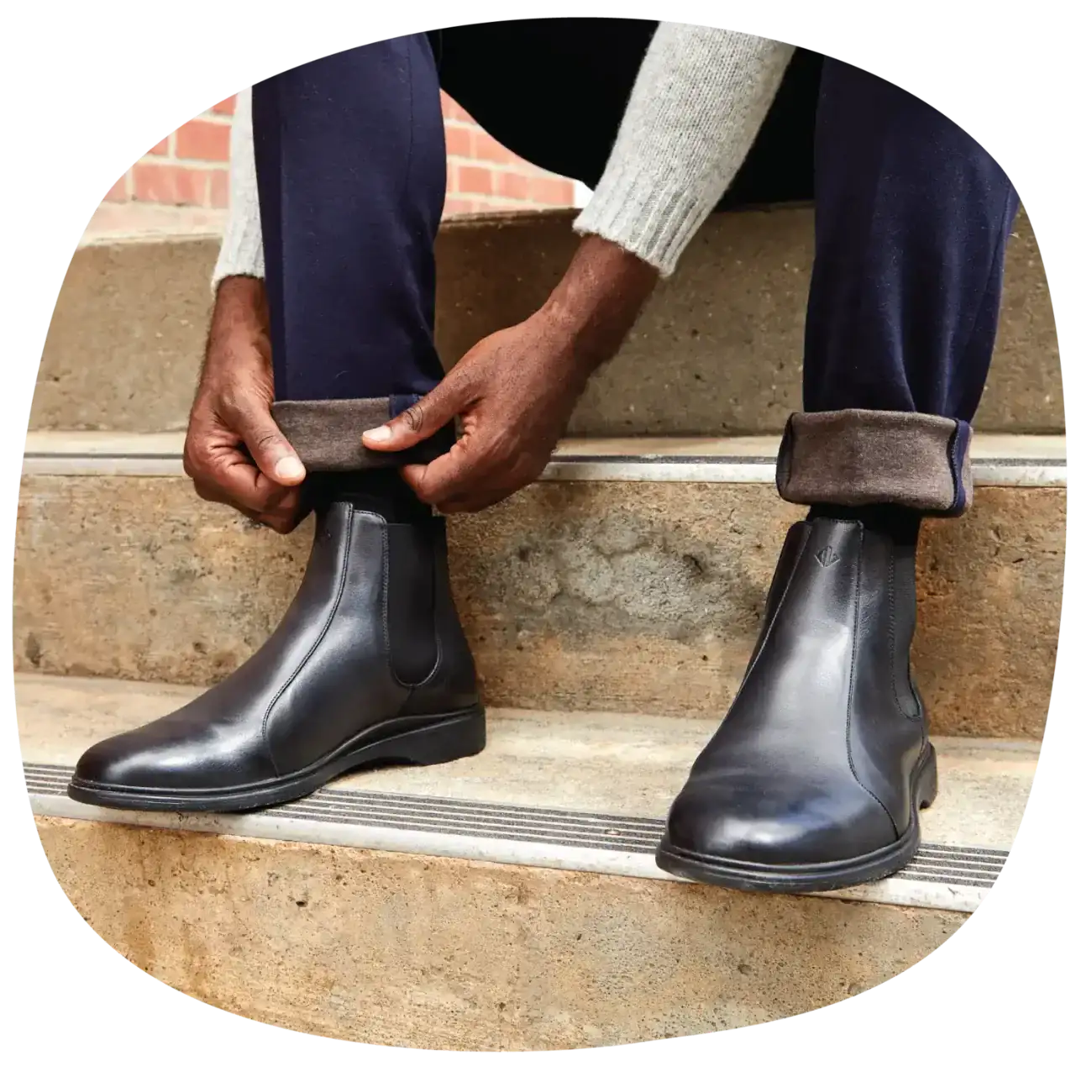  A person fixing their pant leg wearing men’s dress shoes with arch support from Amberjack