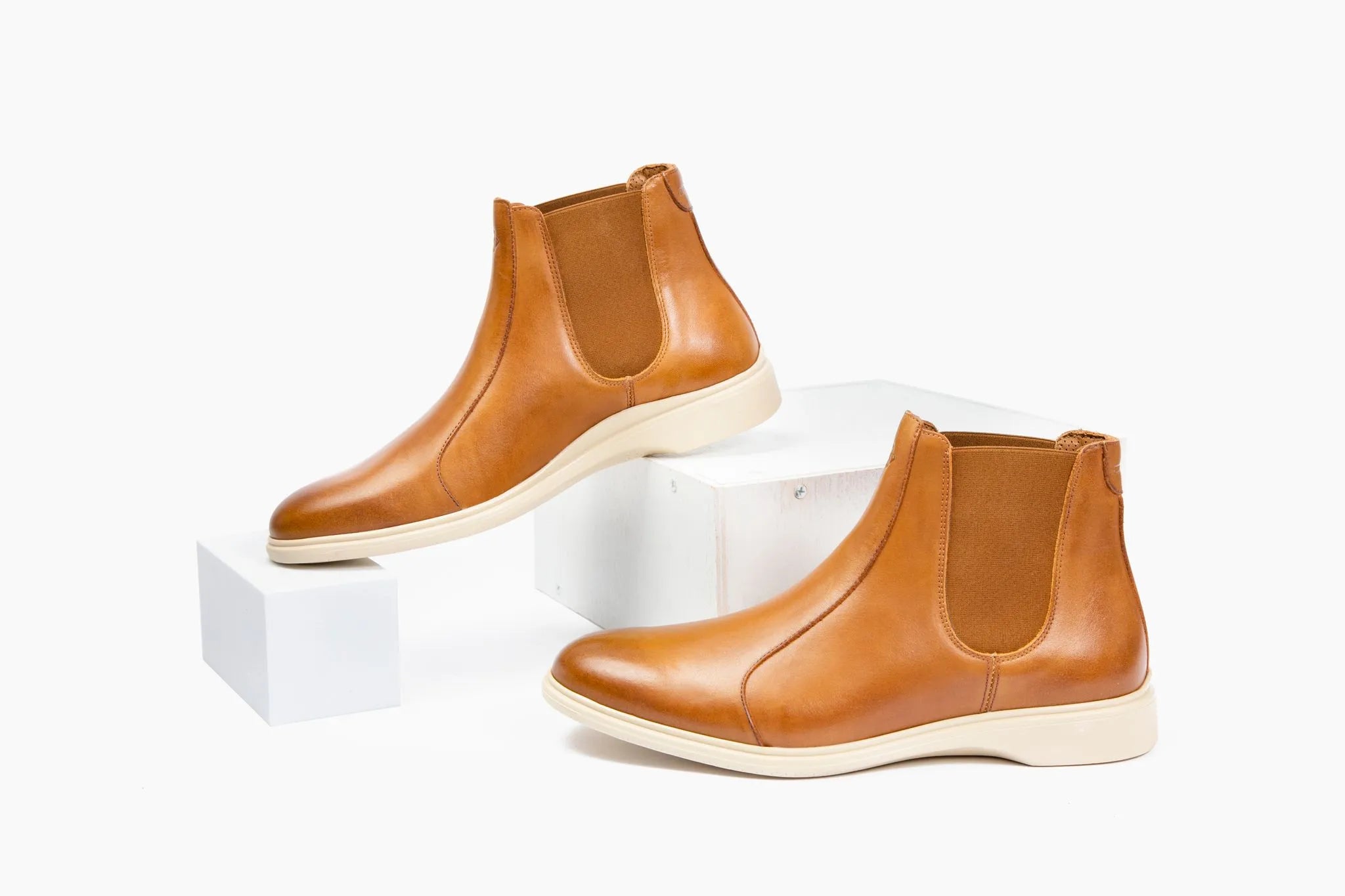 Image of Chelsea boots tilted against white wooden blocks