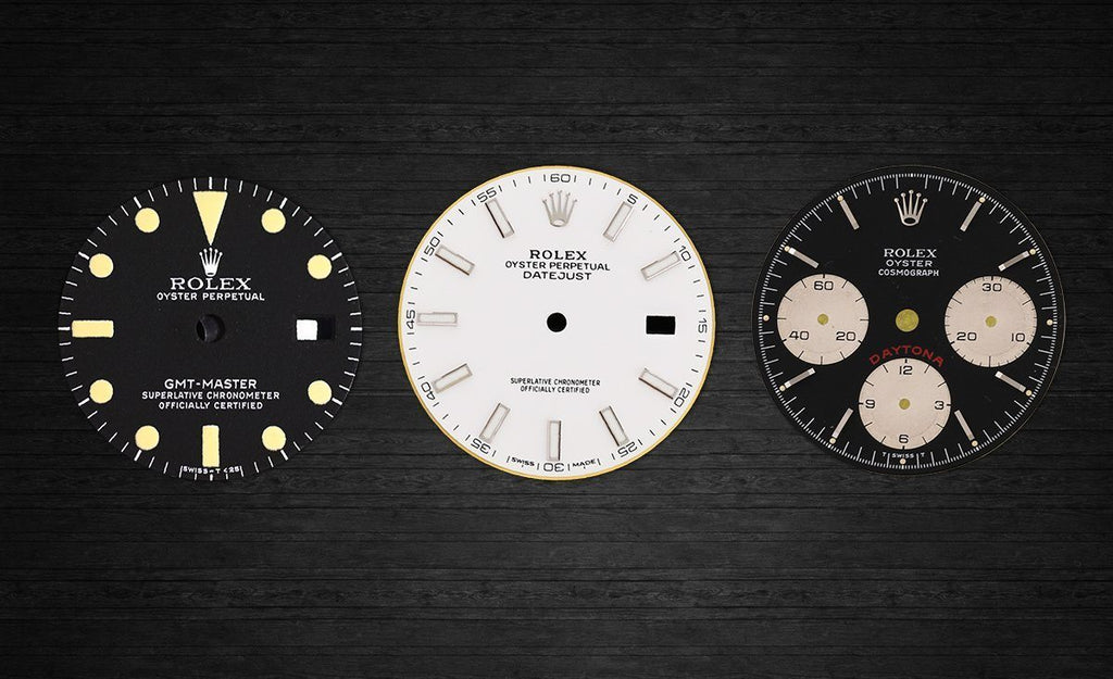 A collection of varied Rolex dials, oldest on the left