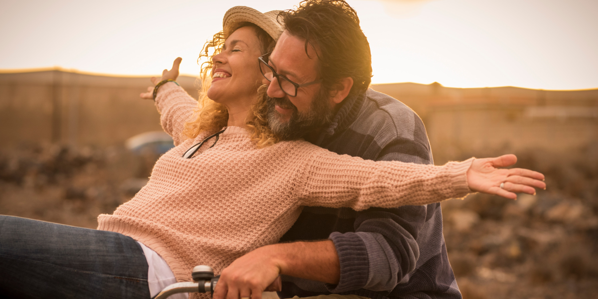 happy mature couple on bike