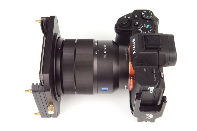 A top down view of a DSLR style camera with lens and Formatt Hitech filter holder system and filter attached to the front of the lens