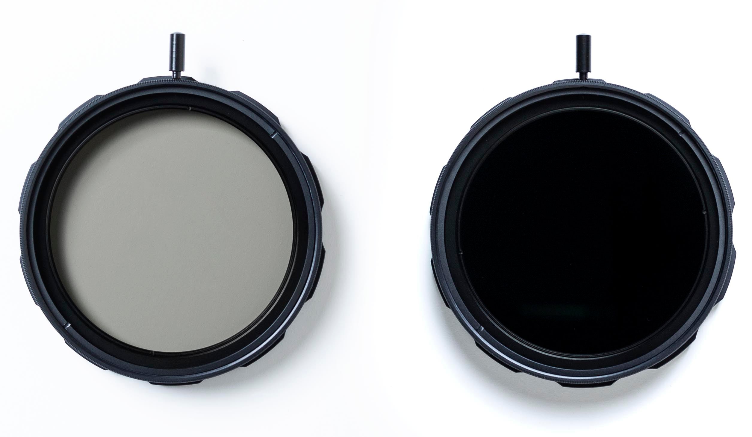 A top down view of two Formatt Hitech round threaded variable ND filters. One is at the minimum setting, the other is set to the maximum light reduction and the filter is very dark.