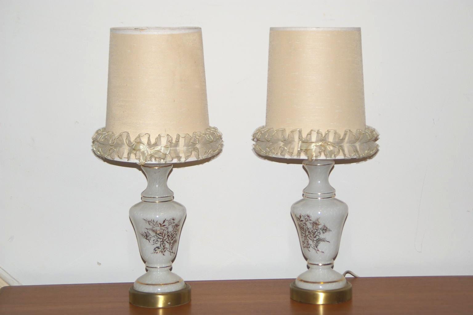 https://cdn.shopify.com/s/files/1/0268/0005/files/i-like-mike-s-mid-century-modern-lighting-pair-white-glass-gold-leaf-boudoir-lamps-354817201_1600x.jpg?v=1690436346