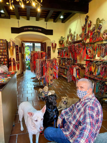 Don Jaime with the dogs in the shop entrance