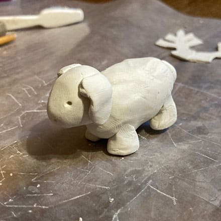 Homeschool science craft project making lamb ornament of clay body and legs