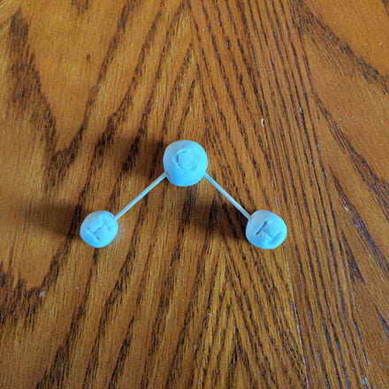 Homeschool science craft project making water molecule shaped ornament of clay bonded