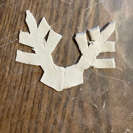 Homeschool science craft project making snowflake ornament of clay joining pieces