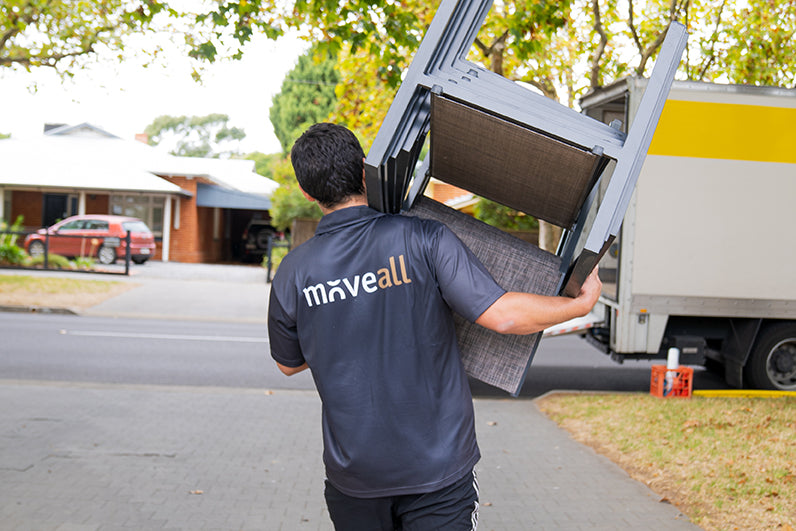 Steve the team member from Moveall holding a moving box