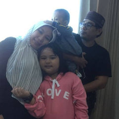 Ayu with her husband, Wandi, and two kids