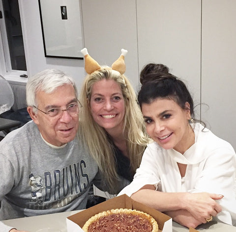 Tara Riceberg, wearing a turkey headband with Paula Abdul, and Ed Riceberg in kitchen with pecan pie