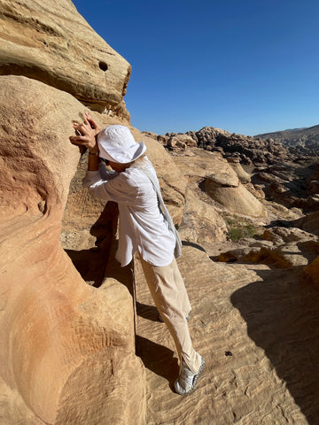 Tara Riceberg leaning into sandstone in Petra, Jordan.