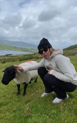 Tara Riceberg, wearing matching outfit with Mary the sheep, Dingle Bay, Ireland