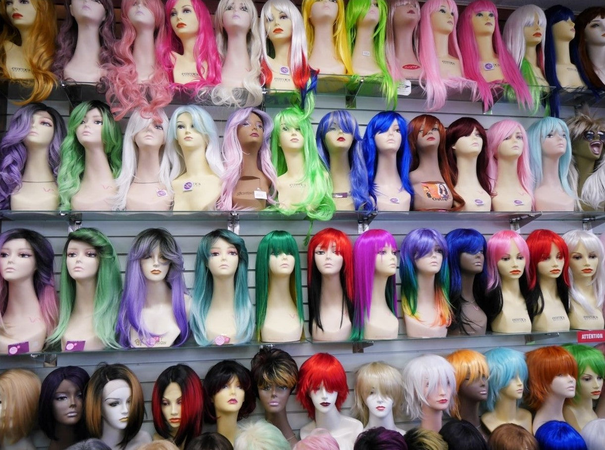 display of many stylish party costume wigs at wig ave