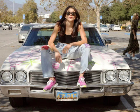 Girl sitting on car