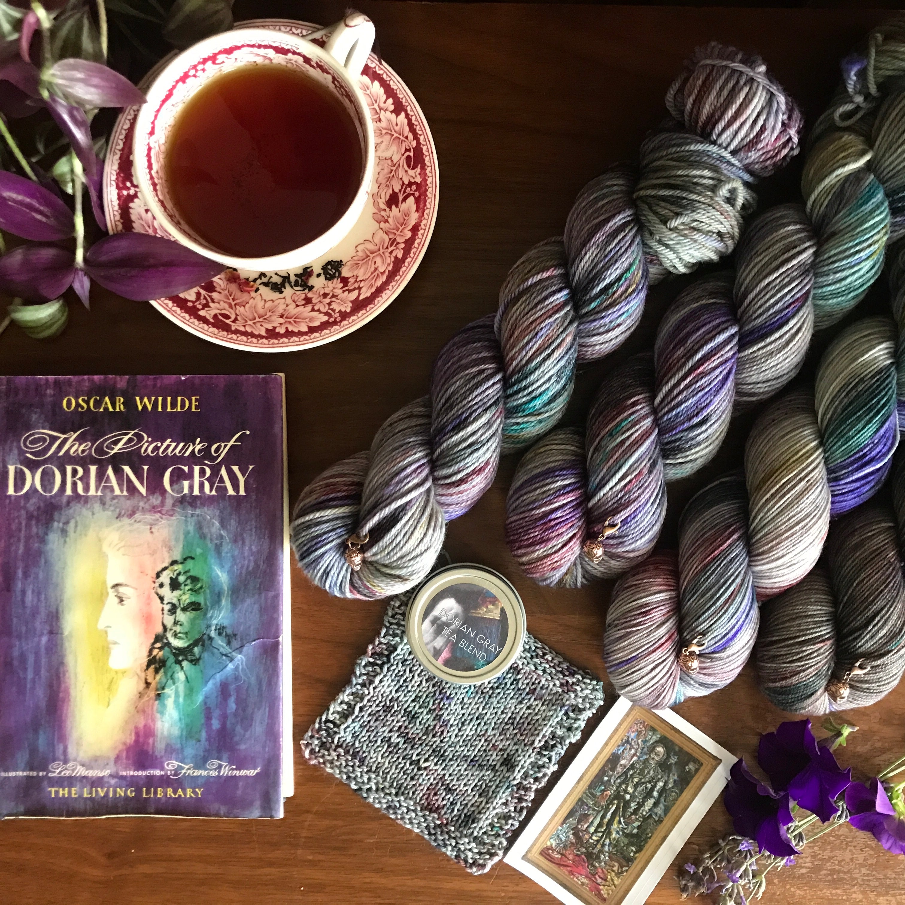 Yarn club inspired by The Picture of Dorian Gray features a floral-gray hand dyed yarn, rose petal infused tea, and skull progress keeper.