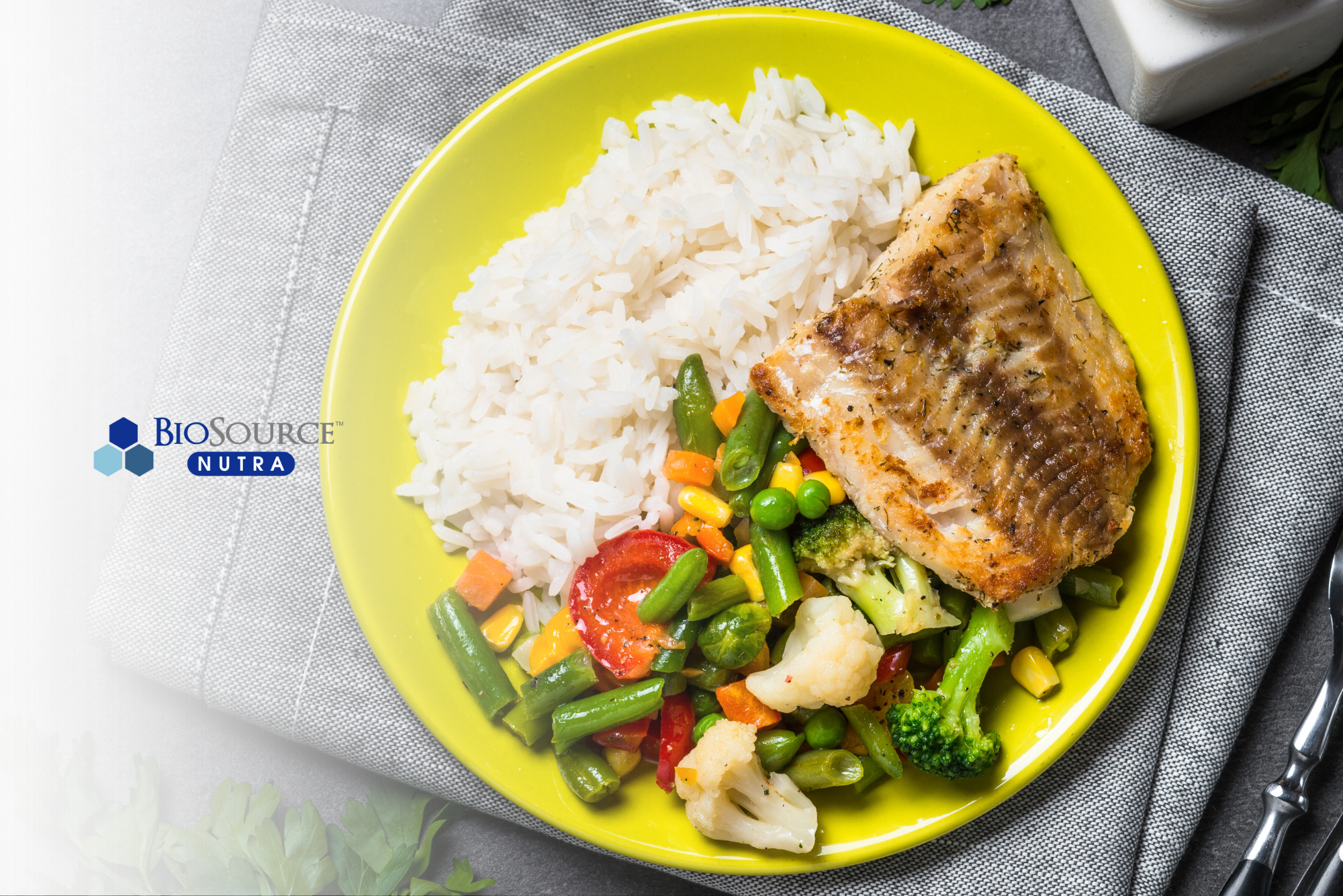A yellow dinner plate with grilled fish, steamed veggies, and white rice