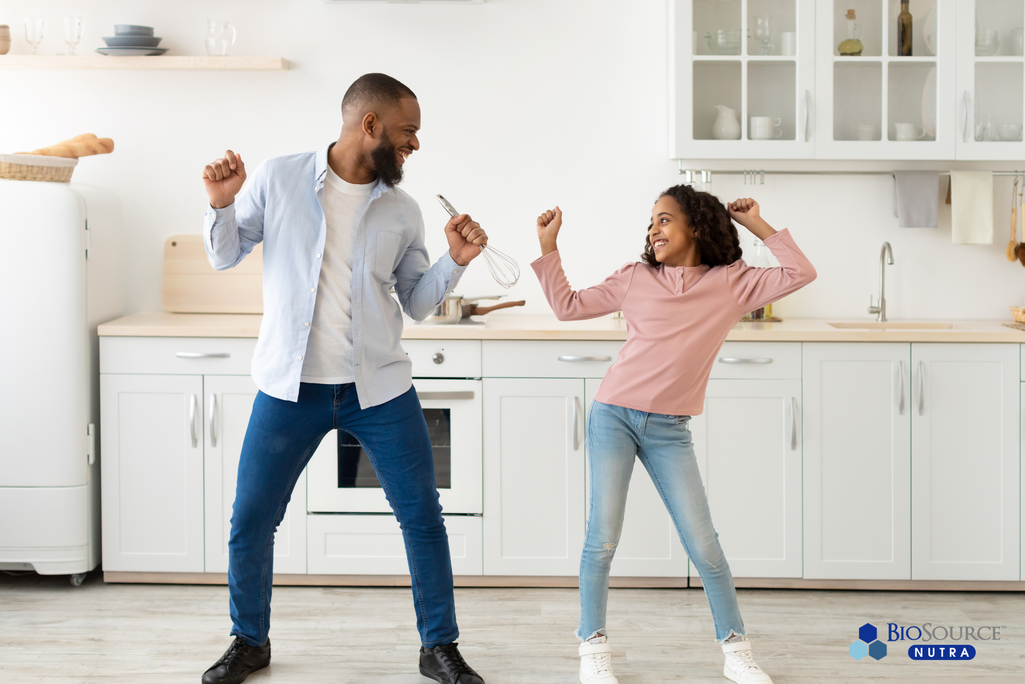 A young man and a little girl dance