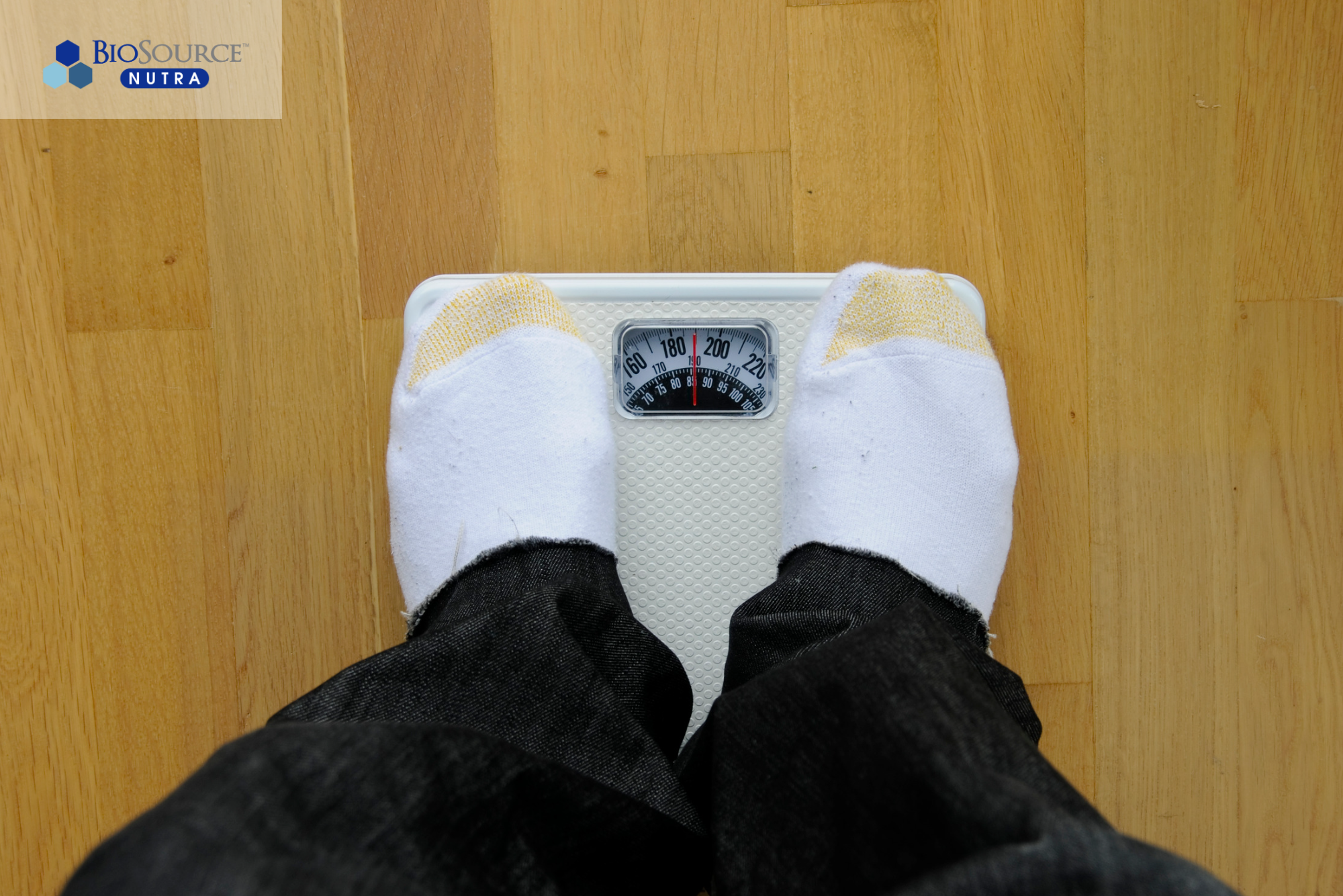 A person is standing on a bathroom scale