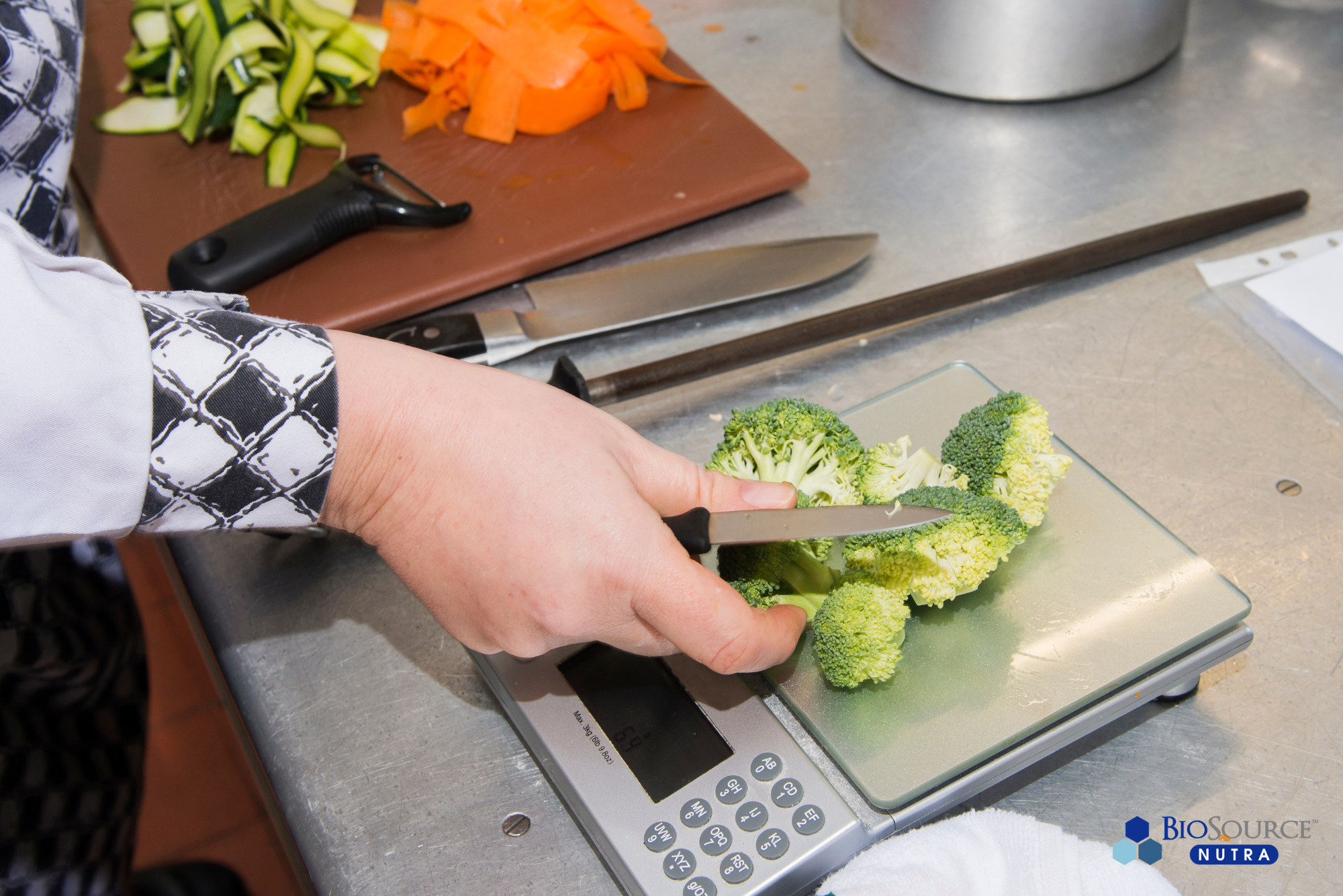 A woman chops and weighs broccoli