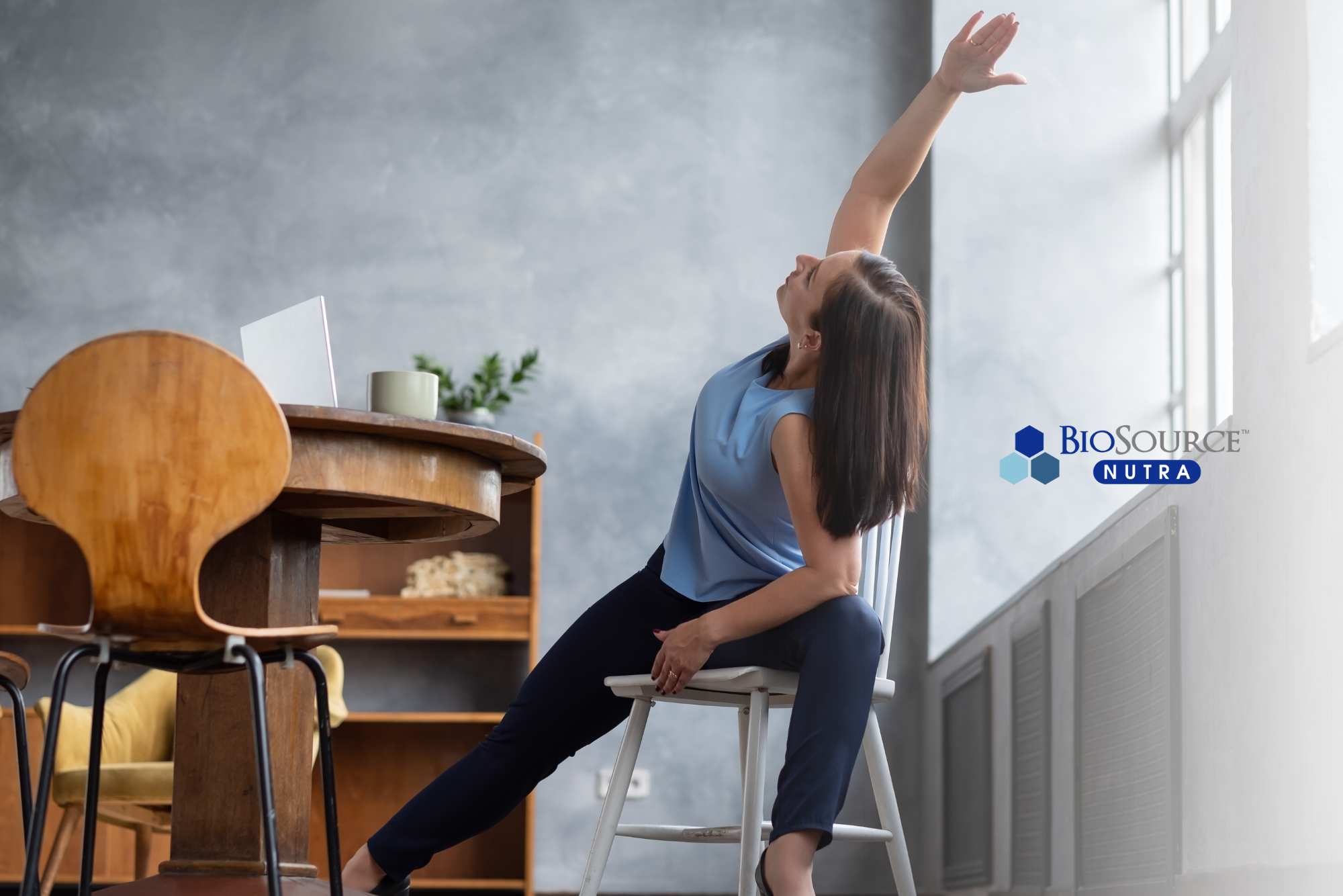 A young woman does stretches while in a chair