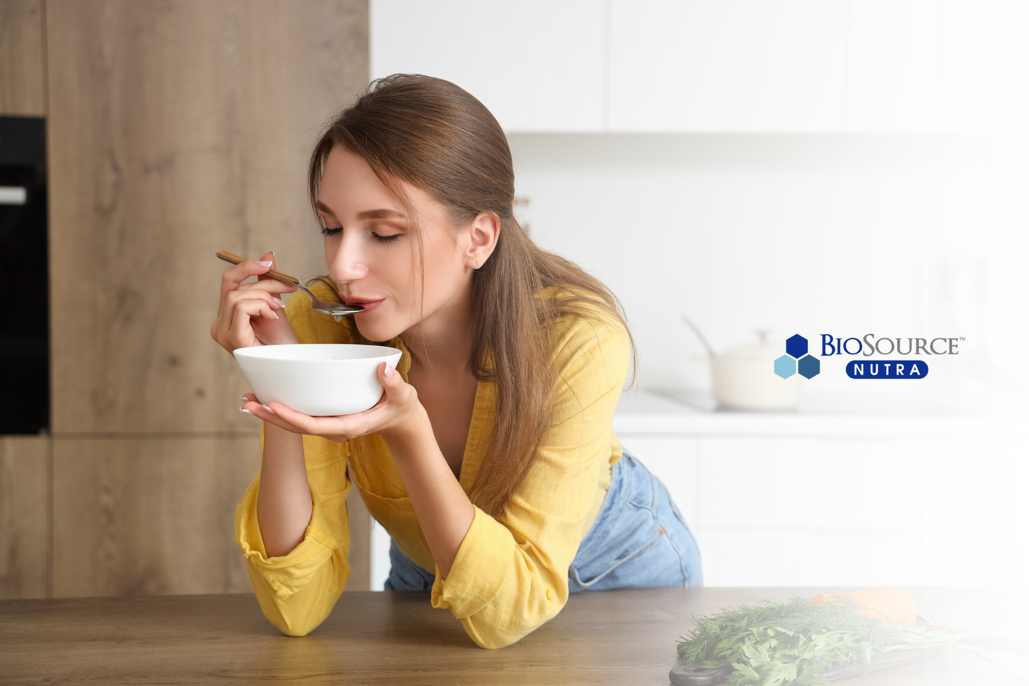 A young woman enjoys warm soup