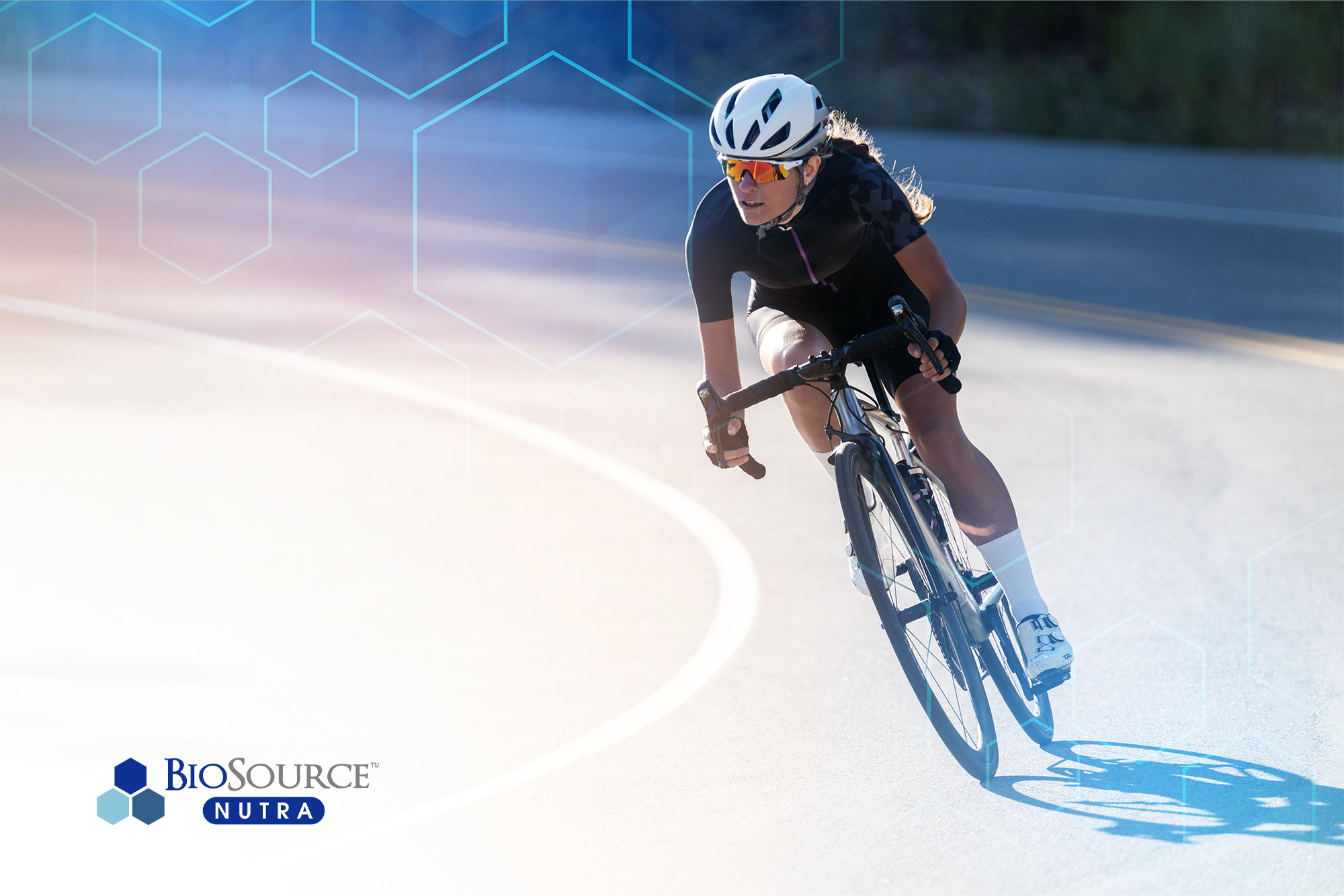 A young man bicycles on a track