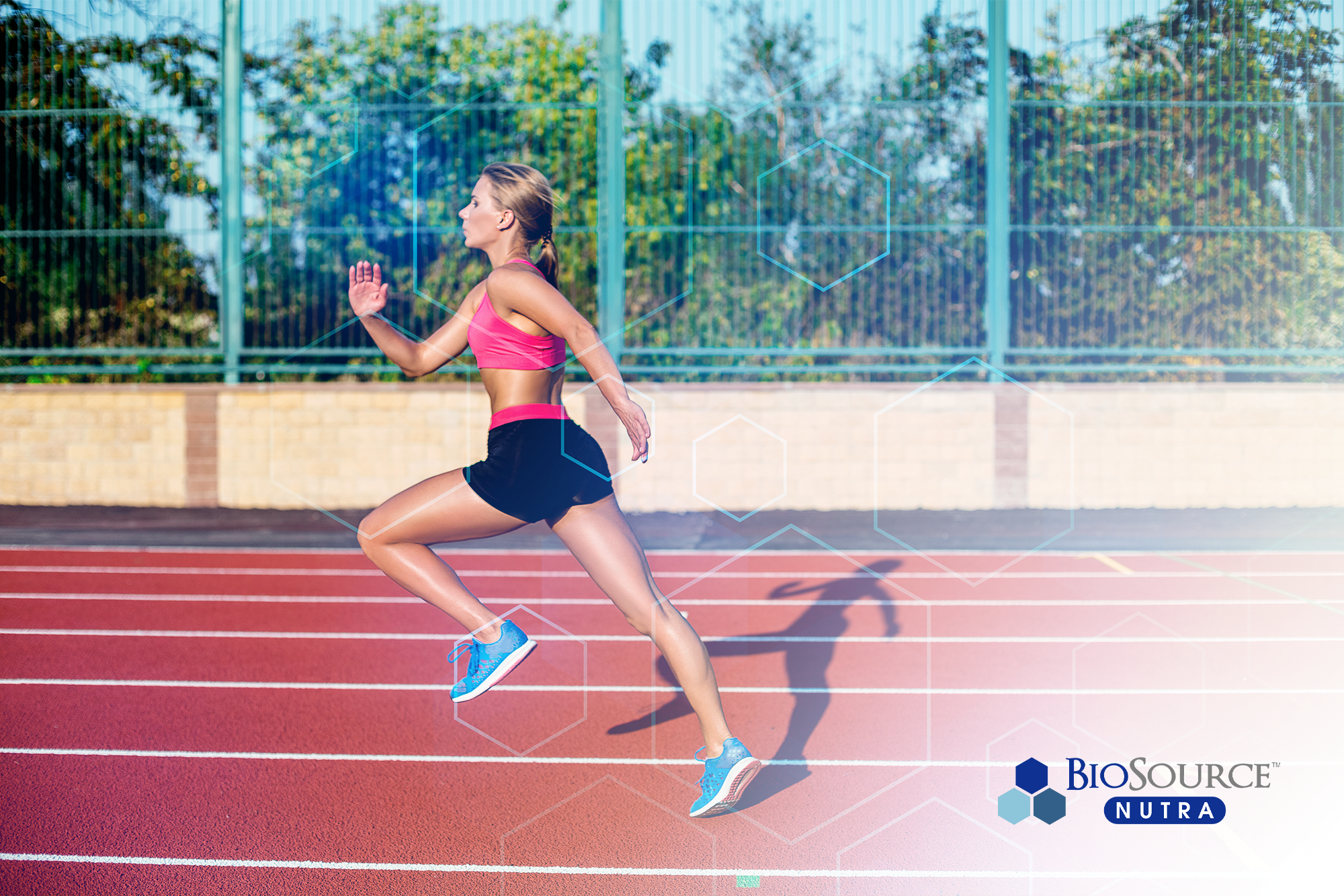 A young woman sprints on a track