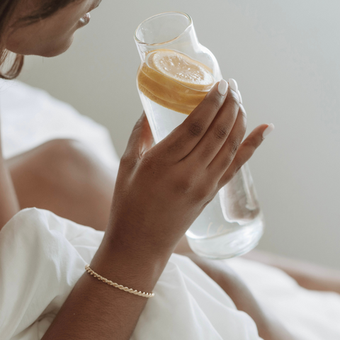 Person drinking water in bed