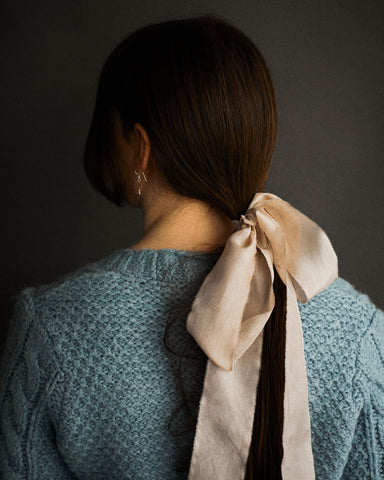 Model with madder rose silk ribbon in hair