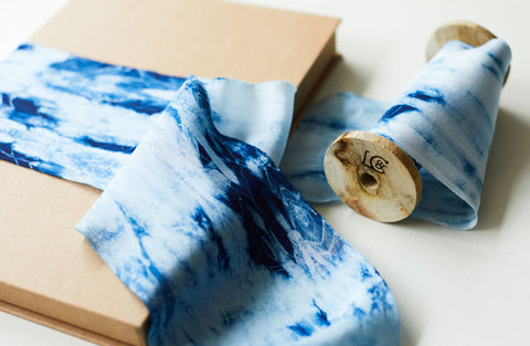 Blue indigo shibori silk ribbon wrapped around a box