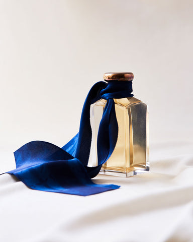 Perfurm bottle tied with indigo silk ribbon