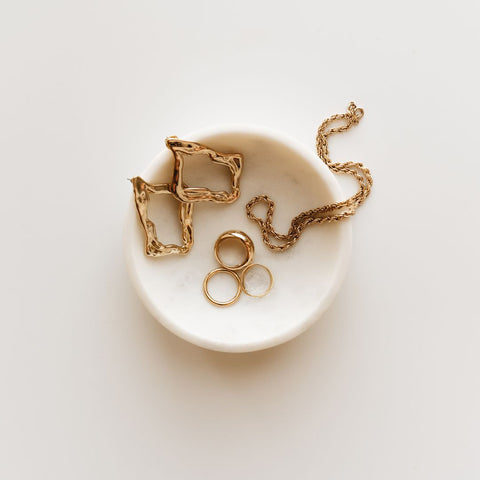 gold jewelry in a small dish