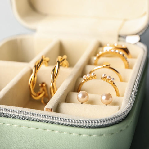 gold jewelry in a small jewelry box