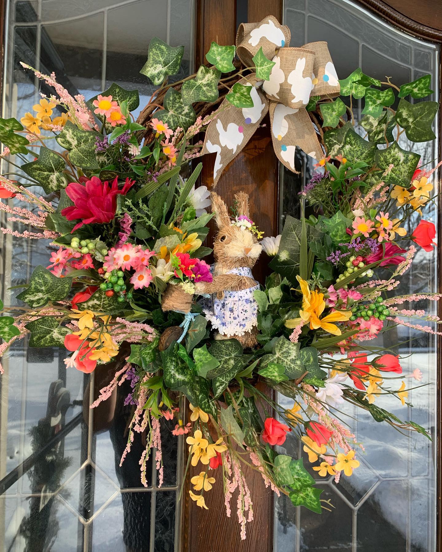 grapevine wreath with wildflowers blooms and grass bunny