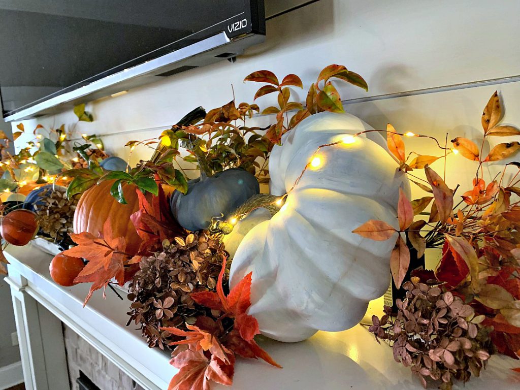 autumn mantel decoration, pumpkins, hydrangeas, tiny lights