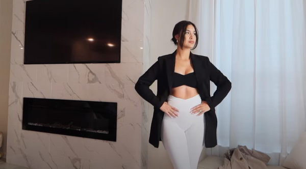 Sandra Rios showcasing white V-waist yoga leggings paired with her favorite coat.