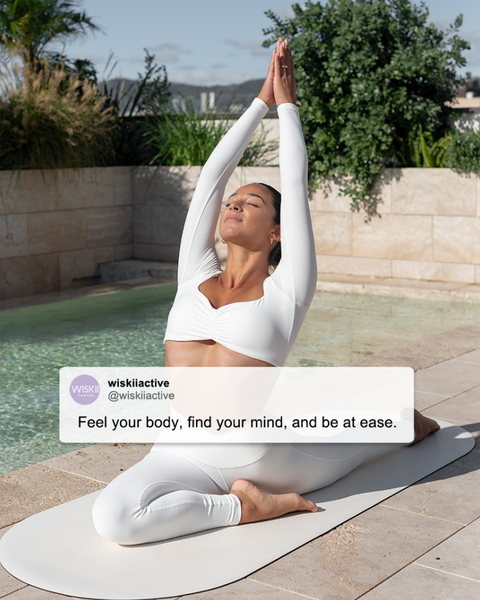 A model enjoys her yoga practice next to the pool