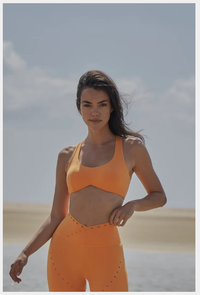 Model showing orange sports bra