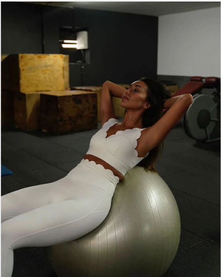 A model wearing comfortable WISKII sportswear uses Stability Balls