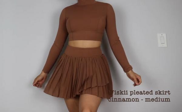 Julissa Pacheco shows off a flowing pleated skirt in cinnamon color