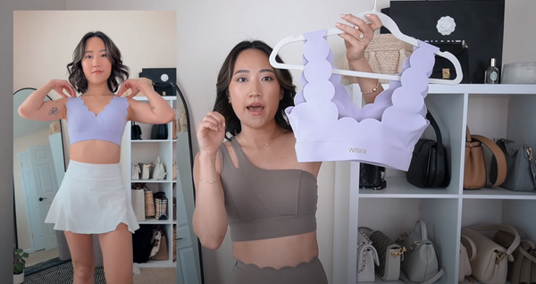 Amy Sun shows everyone a purple sports bra paired with a white A-line skirt