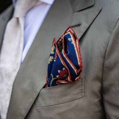 beige suit with pocket square