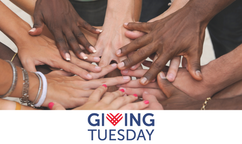 Volunteers putting their hands together for Giving Tuesday