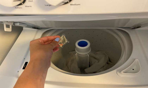 adding detergent pod to washing machine