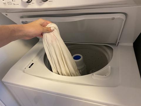 Adding a white shirt to the laundry machine