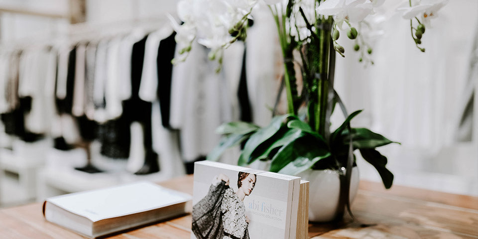 Imagery of the Abi Fisher Cheshire shop with blurred background of clothing and interior