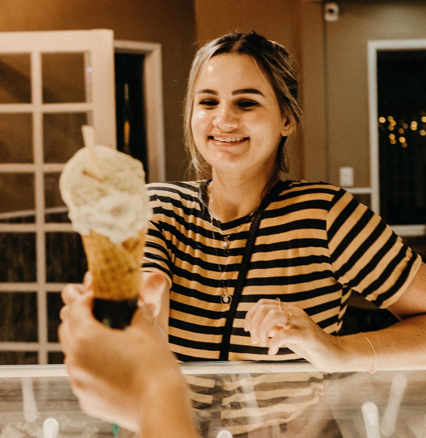 Woman Recieving Ice Cream at Shop