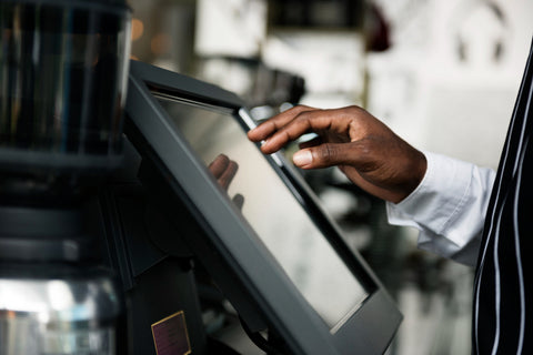 Hand using a POS system