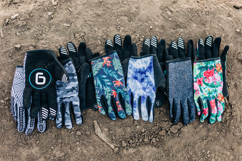 Gripit gloves laid out in a line on mountain bike trail in Midway, Utah.