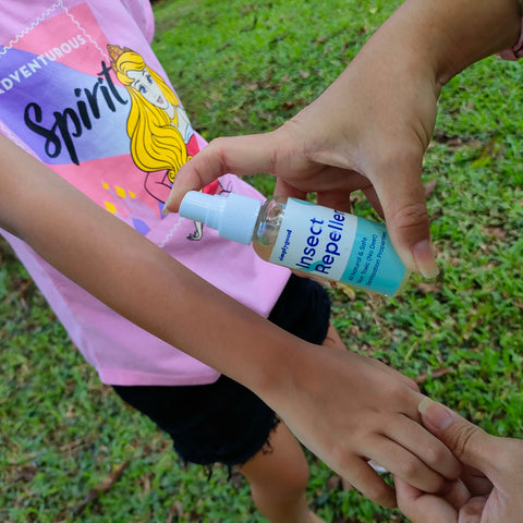 Spraying SimplyGood's All-Natural Insect Repellent on arm